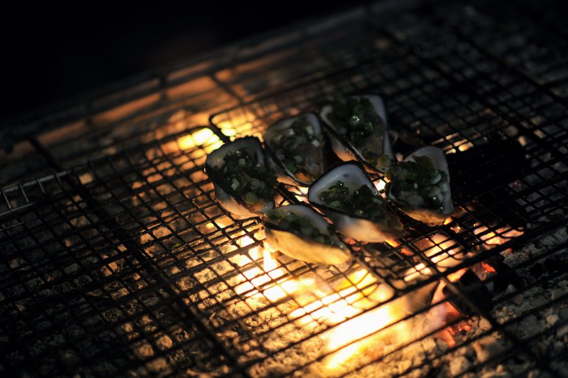 Oysters grilling at night